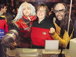 A trio of DragonCon 2001 attendees, one of whom, significantly, is a woman.